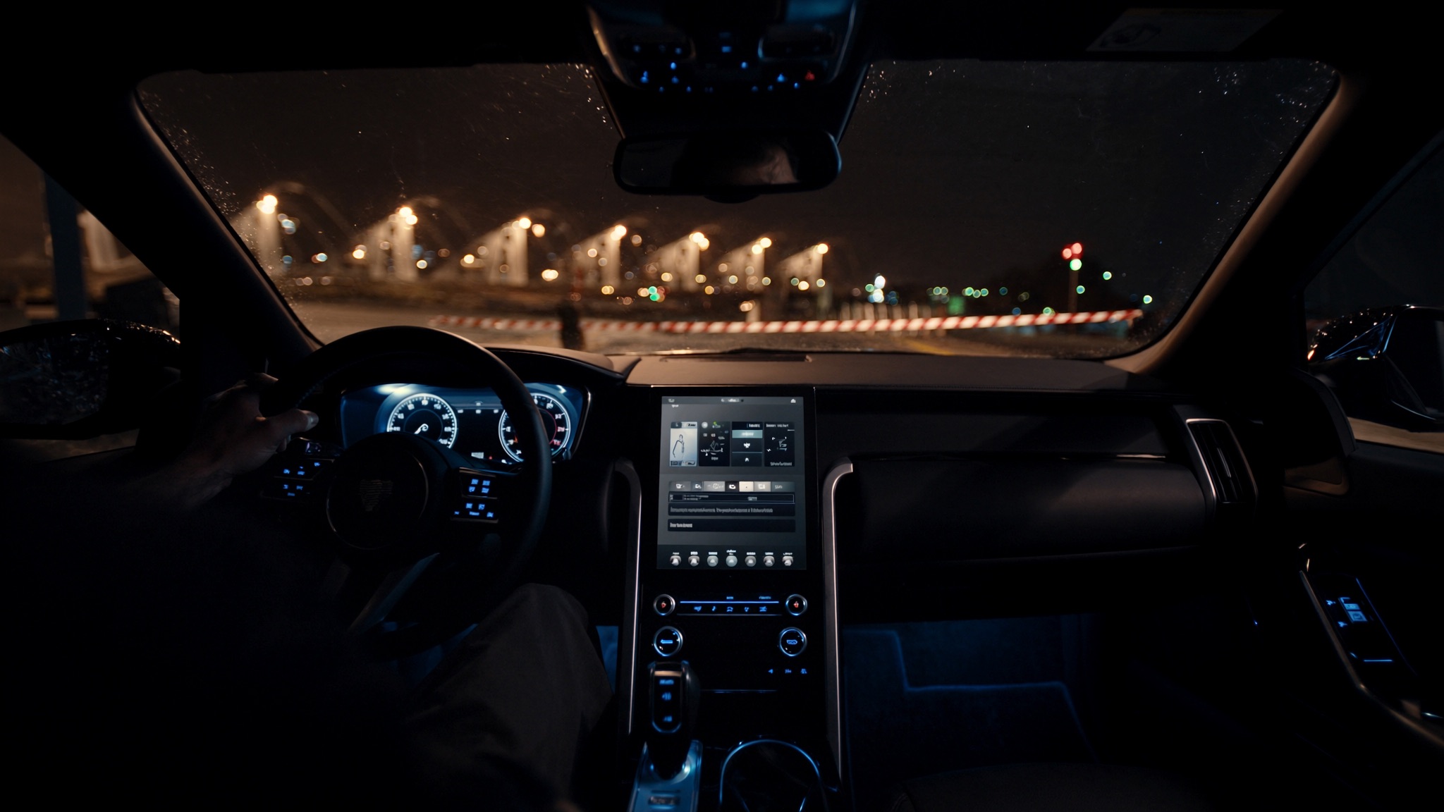 Inside a premium vehicle approaching a checkpoint at night